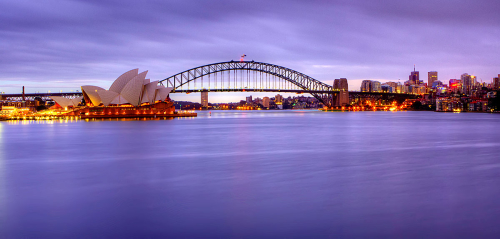 A Pre-dawn photo of Sydney Harbour, overlooking the Opera House and Harbour Bridge